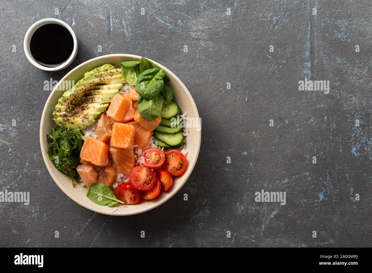 Tasty and healthy food concept Organic poke bowl with salmon, avocado, vegetables and chia seeds Stock Photo