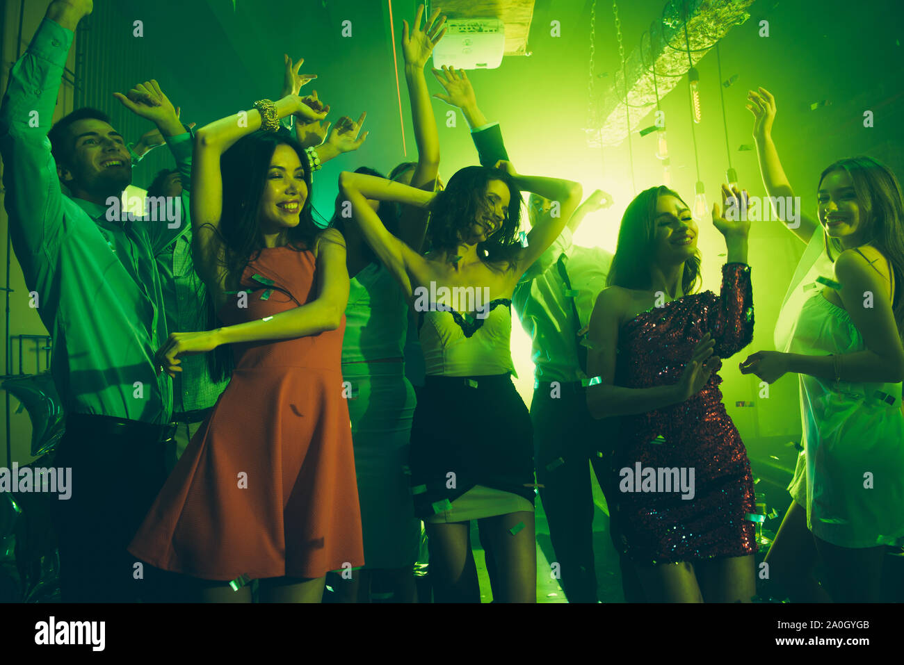 Rest relax chill concept. People dancing in party club with neon lights,  ladies close eyes and raised hands up, mans stand on background Stock Photo  - Alamy