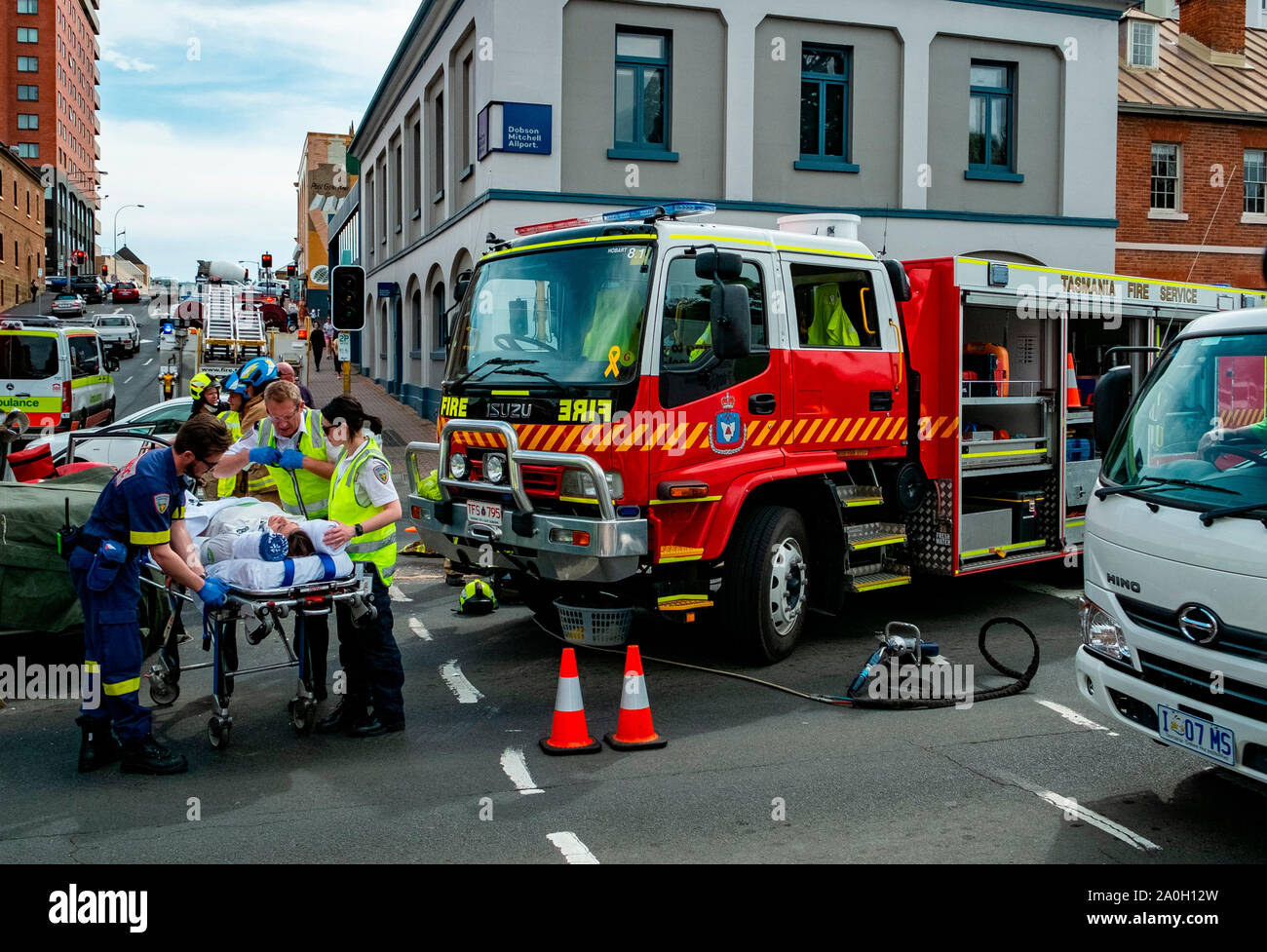Firemen, police and paramedics rescue a woman who was trapped in her car in a traffic accident in the Hobart CBD Friday September 20 2019 Stock Photo