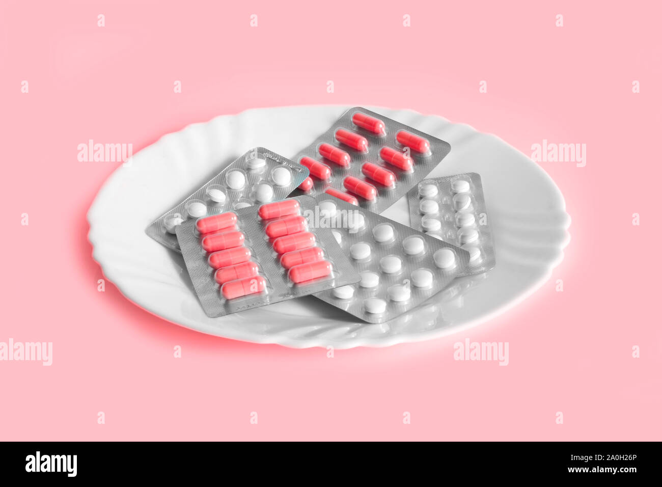 Different pills on a plate. The concept of prescription drugs for weight loss. Means for suppressing appetite. Stock Photo