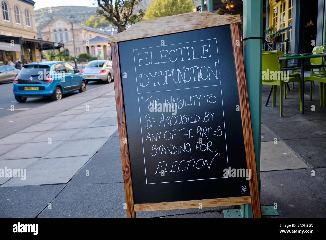 Cafe sign reading 'Electile Dysfunction' on a black board easel on a side walk in Wales Stock Photo