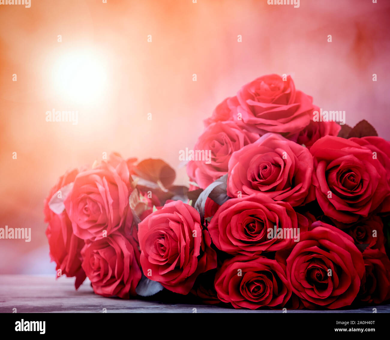 close up beautiful red roses bouguet with glowing light background ...
