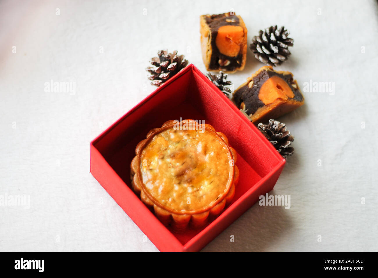 Traditional mooncake inside a red box, eaten during the  Mid-Autumn Festival Stock Photo