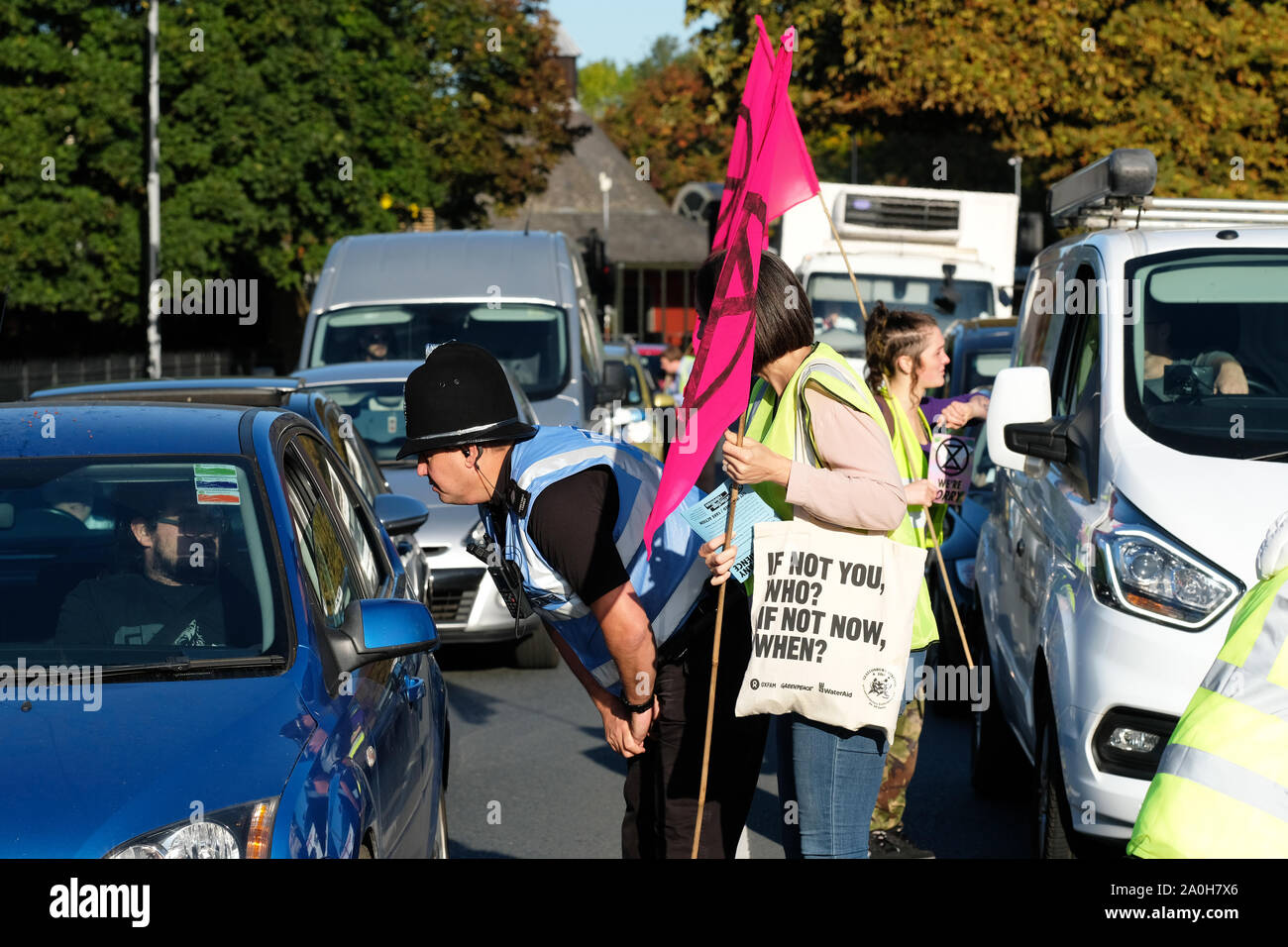 Worcester, Worcestershire, UK – Friday 20th September 2019 – A Police officer reassures a motorist as Extinction Rebellion ( XR ) climate protesters and activists block commuter roads and traffic during the morning rush hour to raise awareness of climate change as part of the XR Global Climate Strike.  Photo Steven May / Alamy Live News Stock Photo