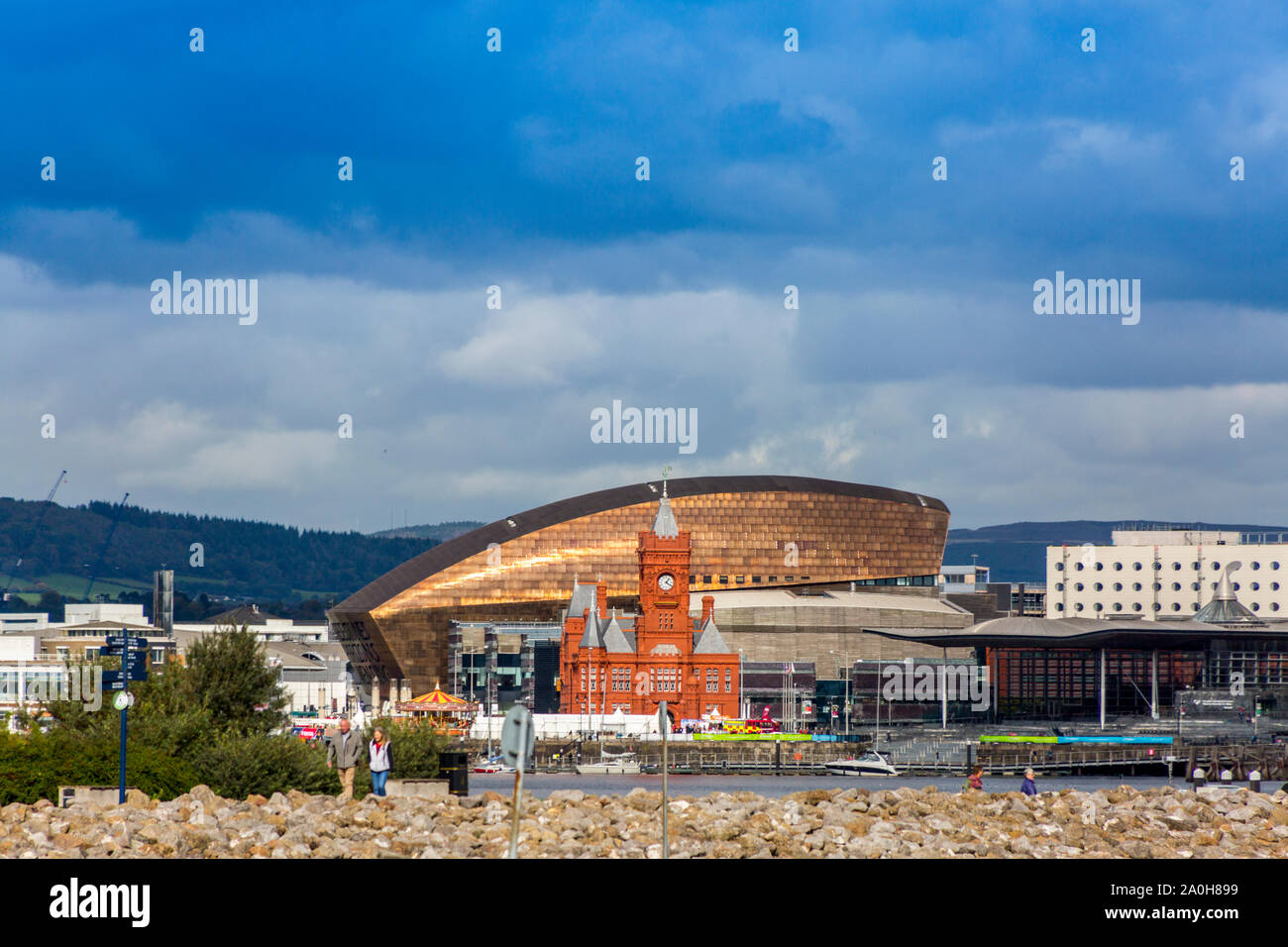A shaft of sunlight lights up the Millennium Centre and red brick Pierhead Building on Cardiff Bay's iconic waterfront, Glamorgan, Wales, UK Stock Photo