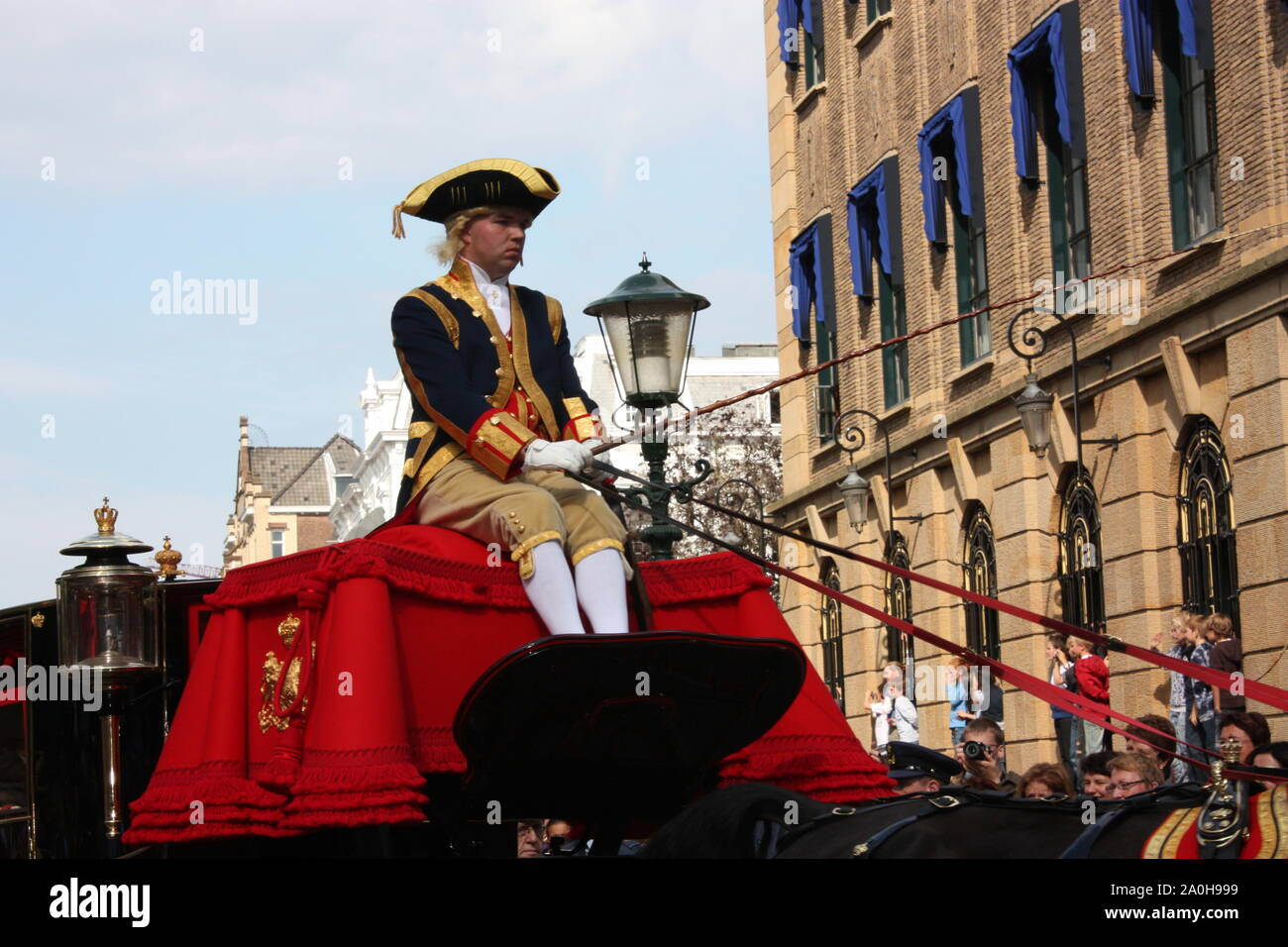 The driver rode on the golden carriage with the Royal family on the way to the Hall of Knights in The Hague at Prinsjesdag annual ceremony. Stock Photo