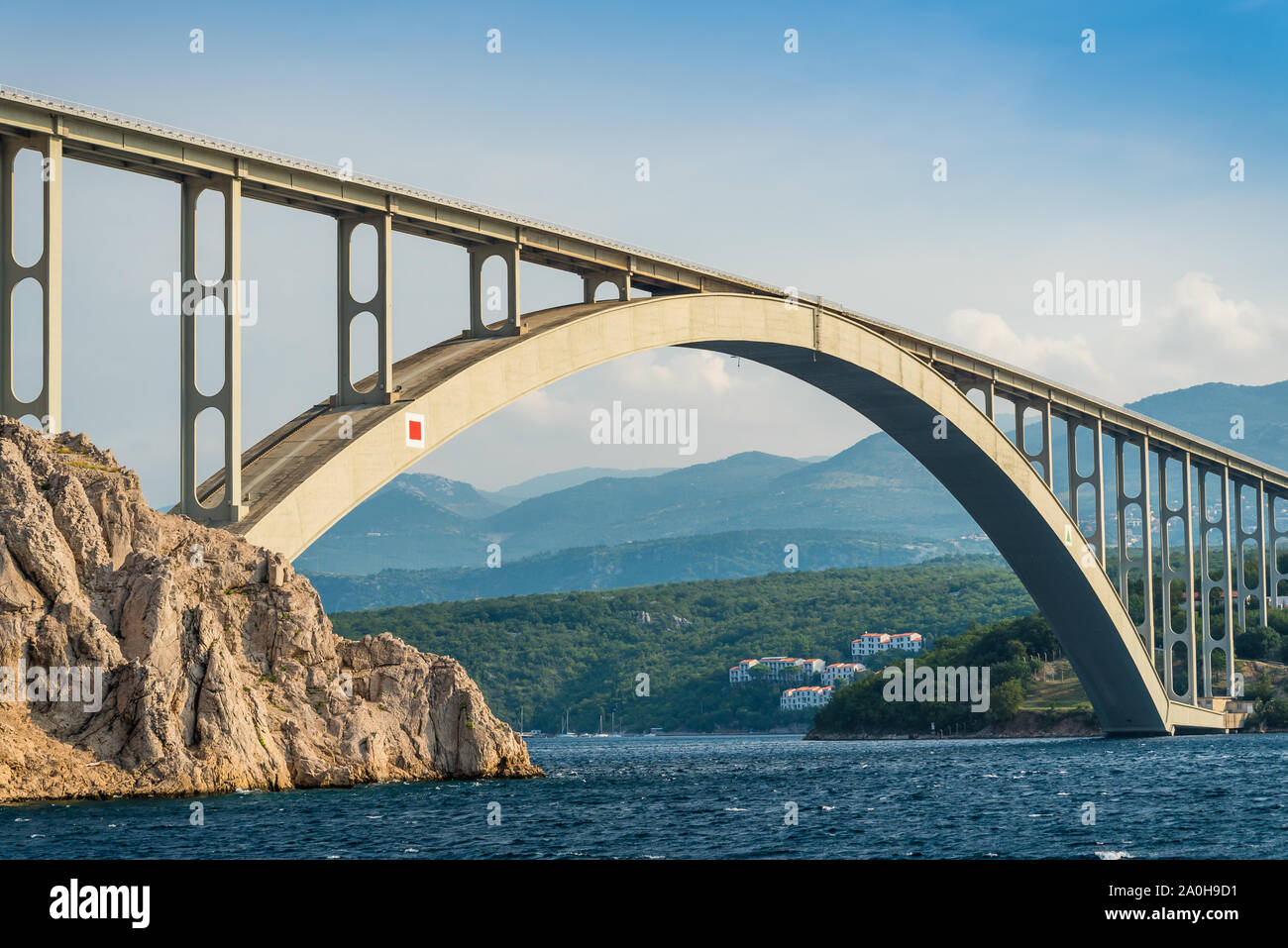 Bridge to the island Krk under blue sky on a sunny summer day. Krk is the big island of the Croatian coast of the Adriatic Sea. Travel landscape Stock Photo