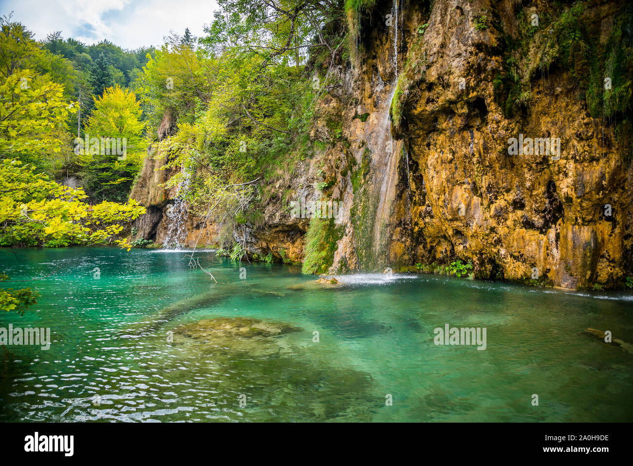 Amazing waterfalls with crystal clear water in the forest in Plitvice lakes National Park, Croatia. Nature landscape Stock Photo