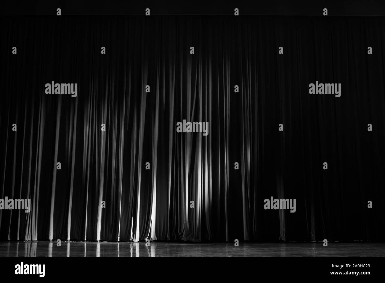 Black and white velvet curtains with the lights of the show and the