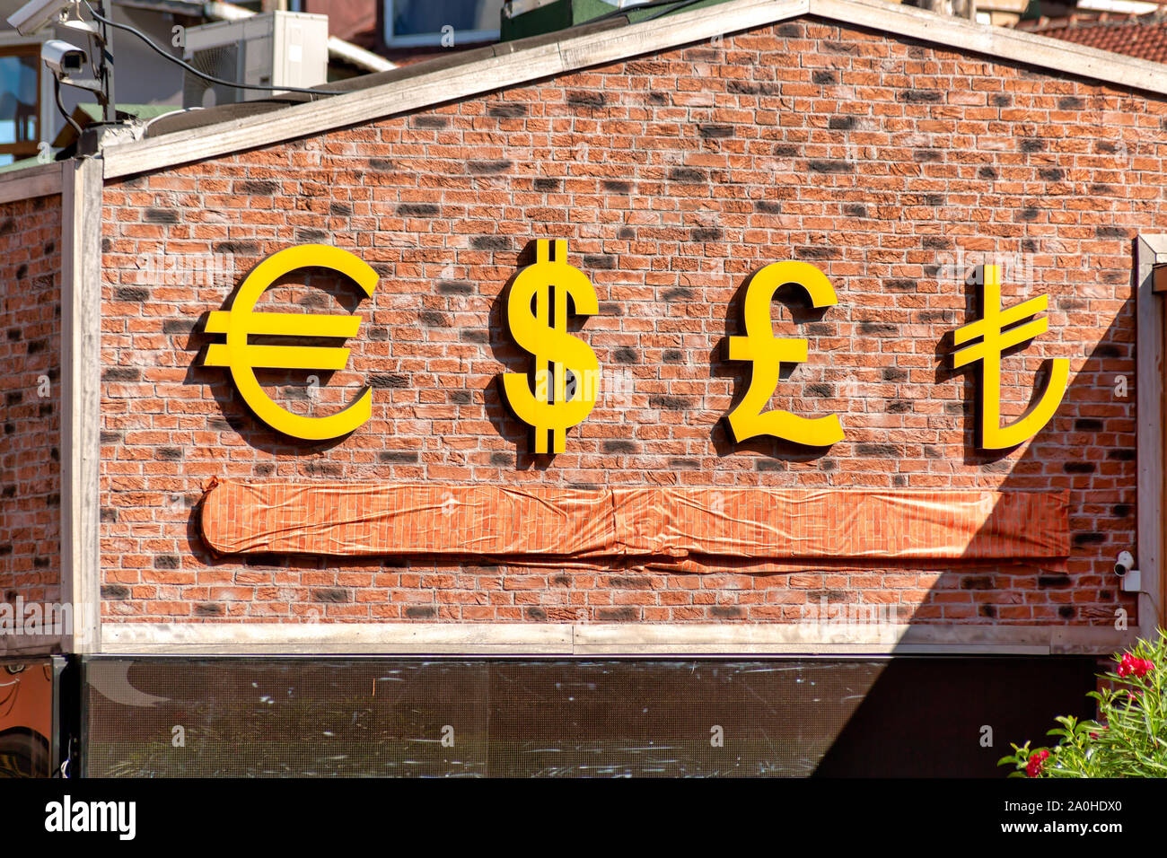 Currency symbols displayed on a brick wall. USD, EUR, GBP and TRY currency signs for Dolar, Euro, Pound and Turkish Lira. Stock Photo