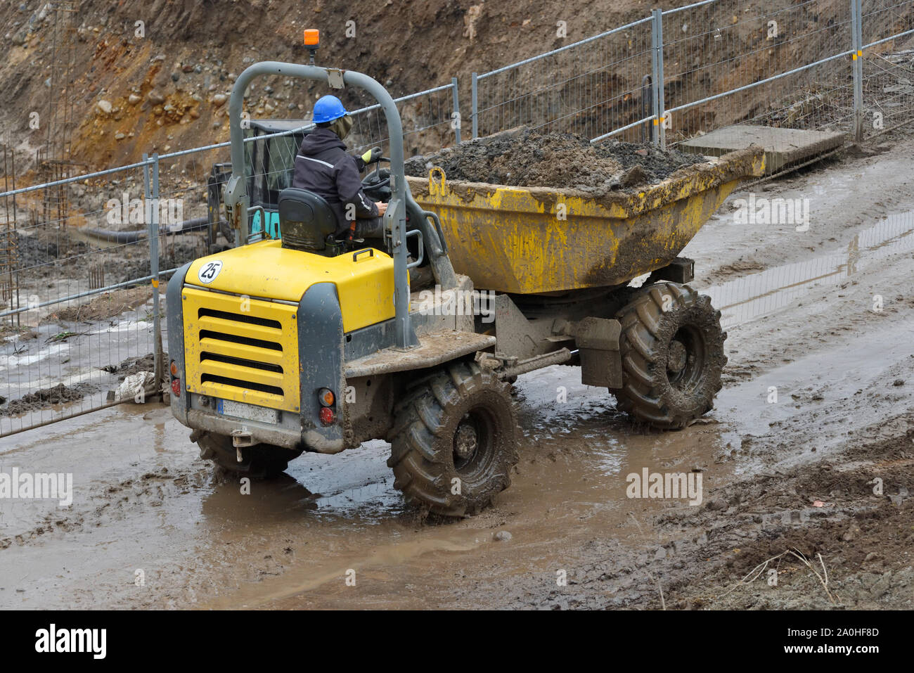 Small Dump Truck hauling ground during road construction Stock Photo