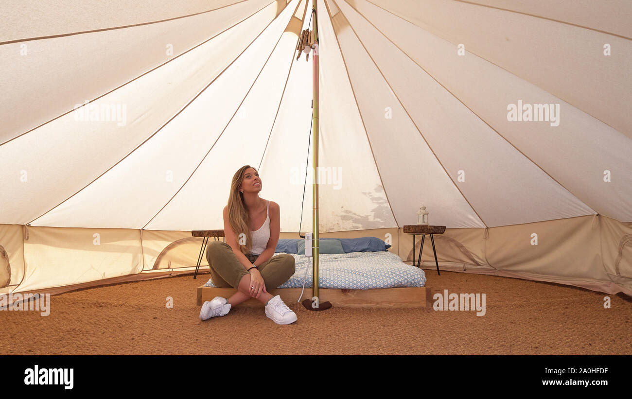 Young woman on the interior of a camping tent Stock Photo