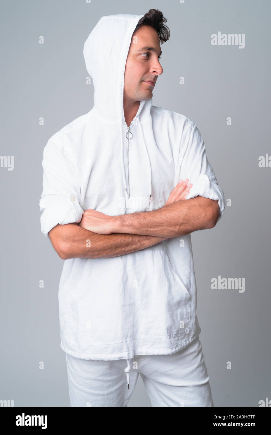 Portrait of handsome Hispanic man looking away with arms crossed Stock ...