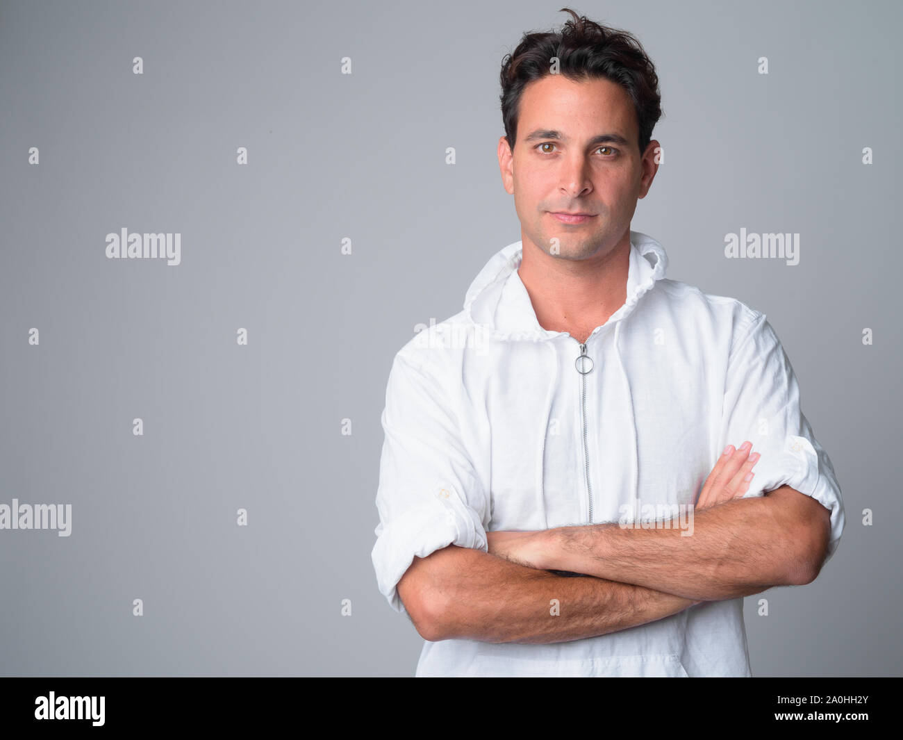 Portrait of handsome Hispanic man with arms crossed Stock Photo - Alamy