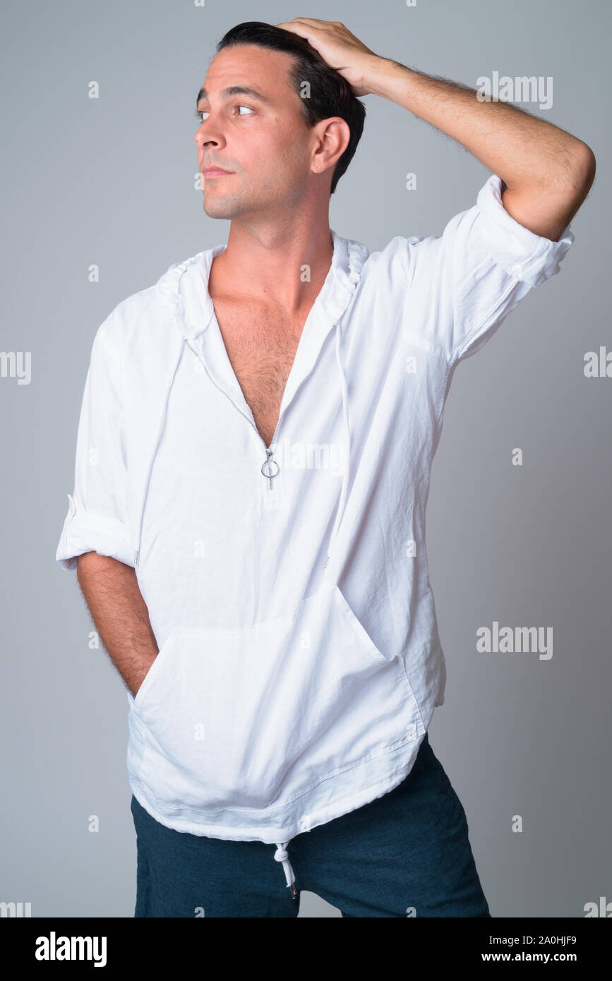 Portrait Of Handsome Hispanic Man Brushing Hair Back Stock Photo