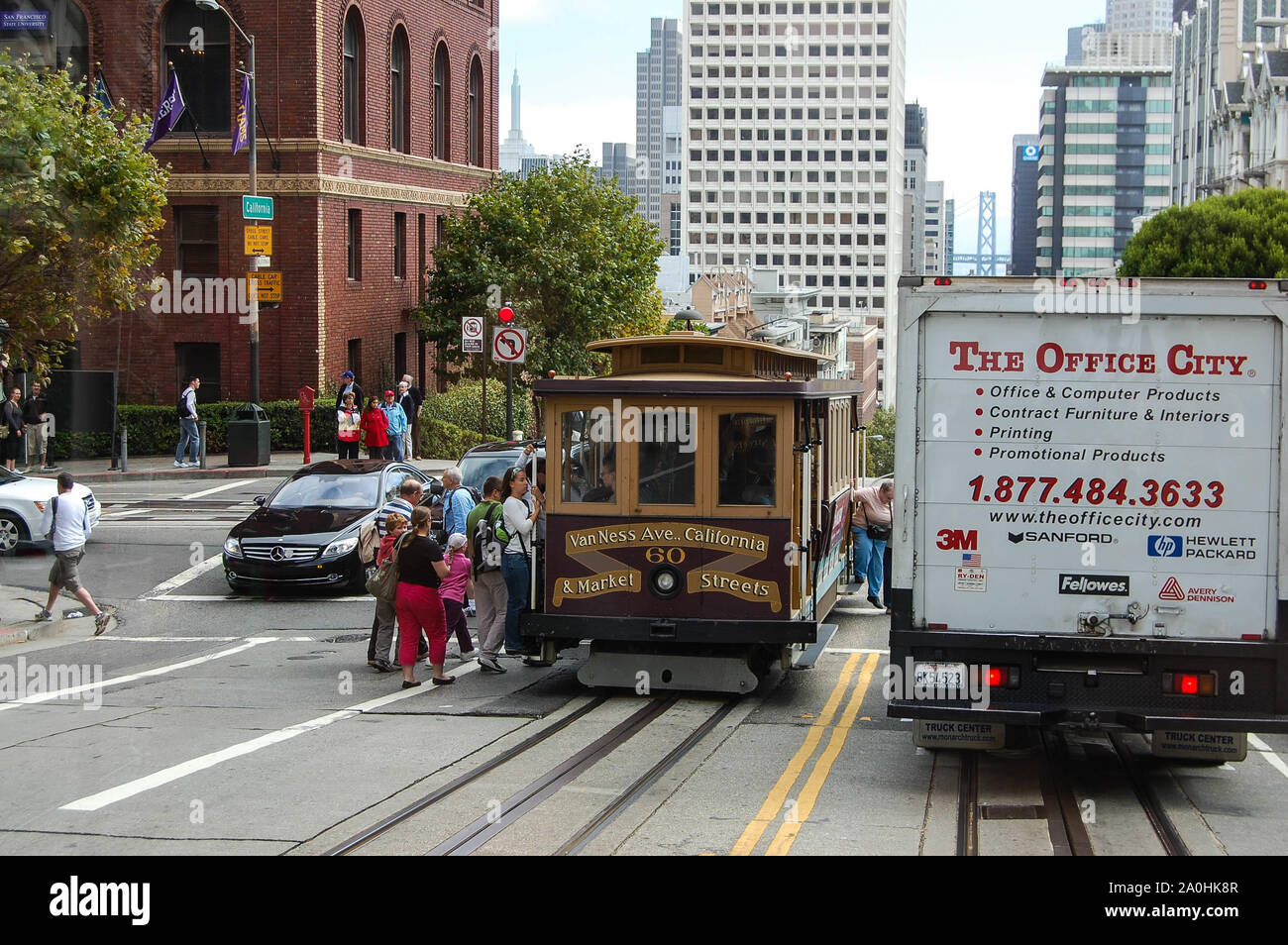 San Francisco California street car type tram and people crossing the