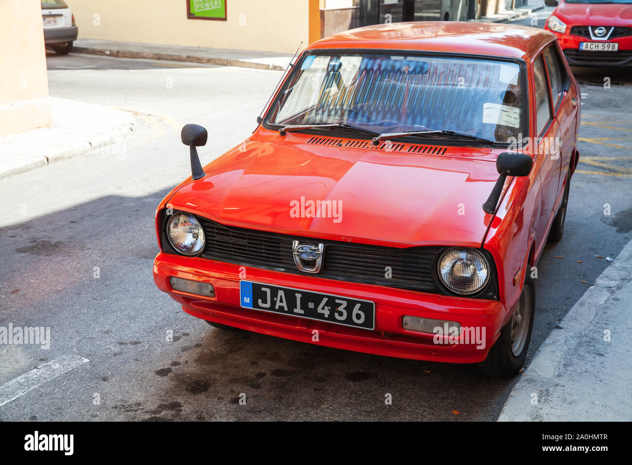 L-Imdina, Malta - August 25, 2019: Red Subaru Rex Combi or Van version car stands parked on a street Stock Photo