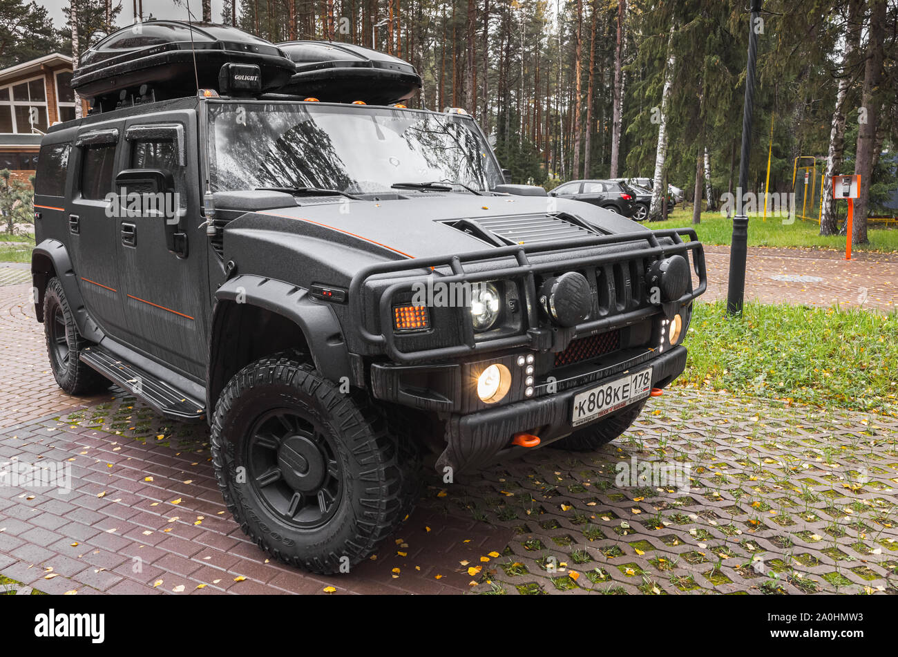Saint-Petersburg, Russia - October 8, 2017: Black Hummer H2 car stands on rural parking lot in Russian countryside, side view Stock Photo