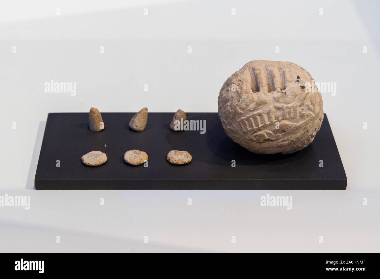 Hollow ball with the tokens it contained (calculi). About 3400-3100BC. Lightly fired clay. Found in Susa, Iran. Stock Photo