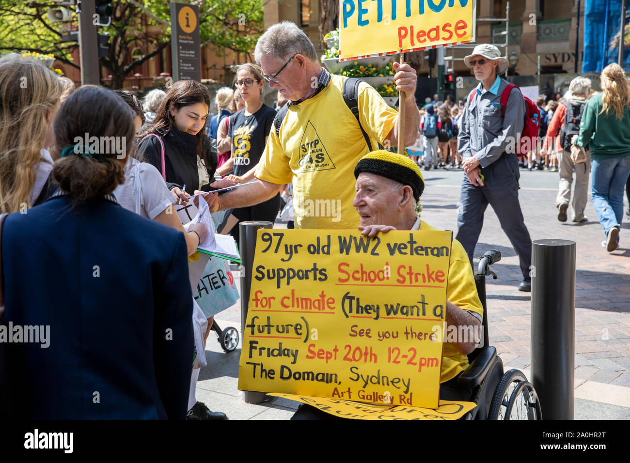 Man in wheelchair holds homemade protest sign at the sydney climate change strike rally,Australia Stock Photo