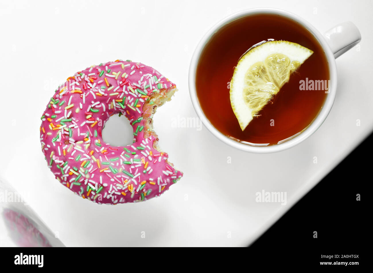 Tea with lemon and a delicious beautiful donut Stock Photo