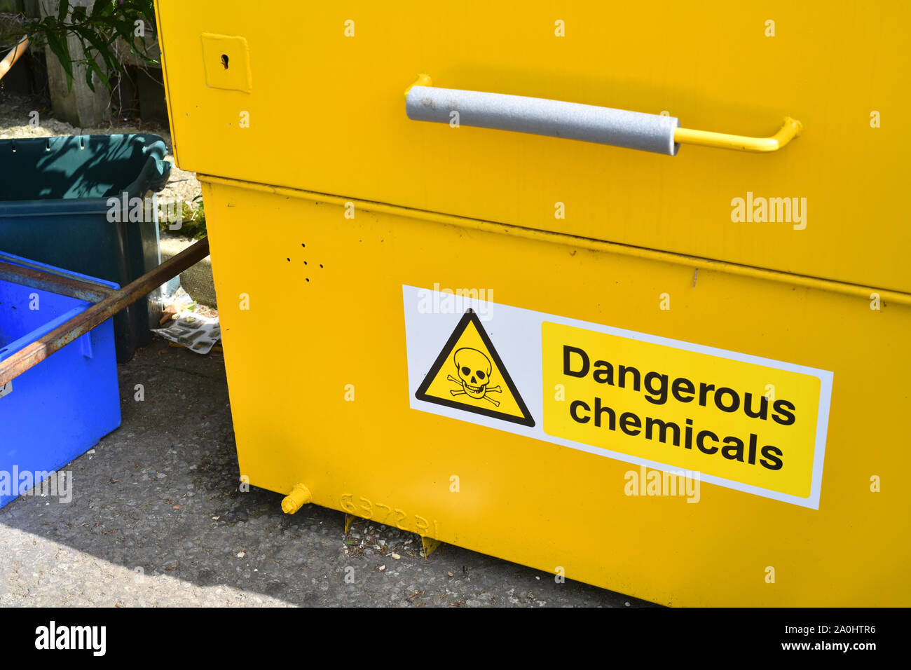 dangerous chemicals warning sign on liquid container at council household recycling centre united kingdom Stock Photo
