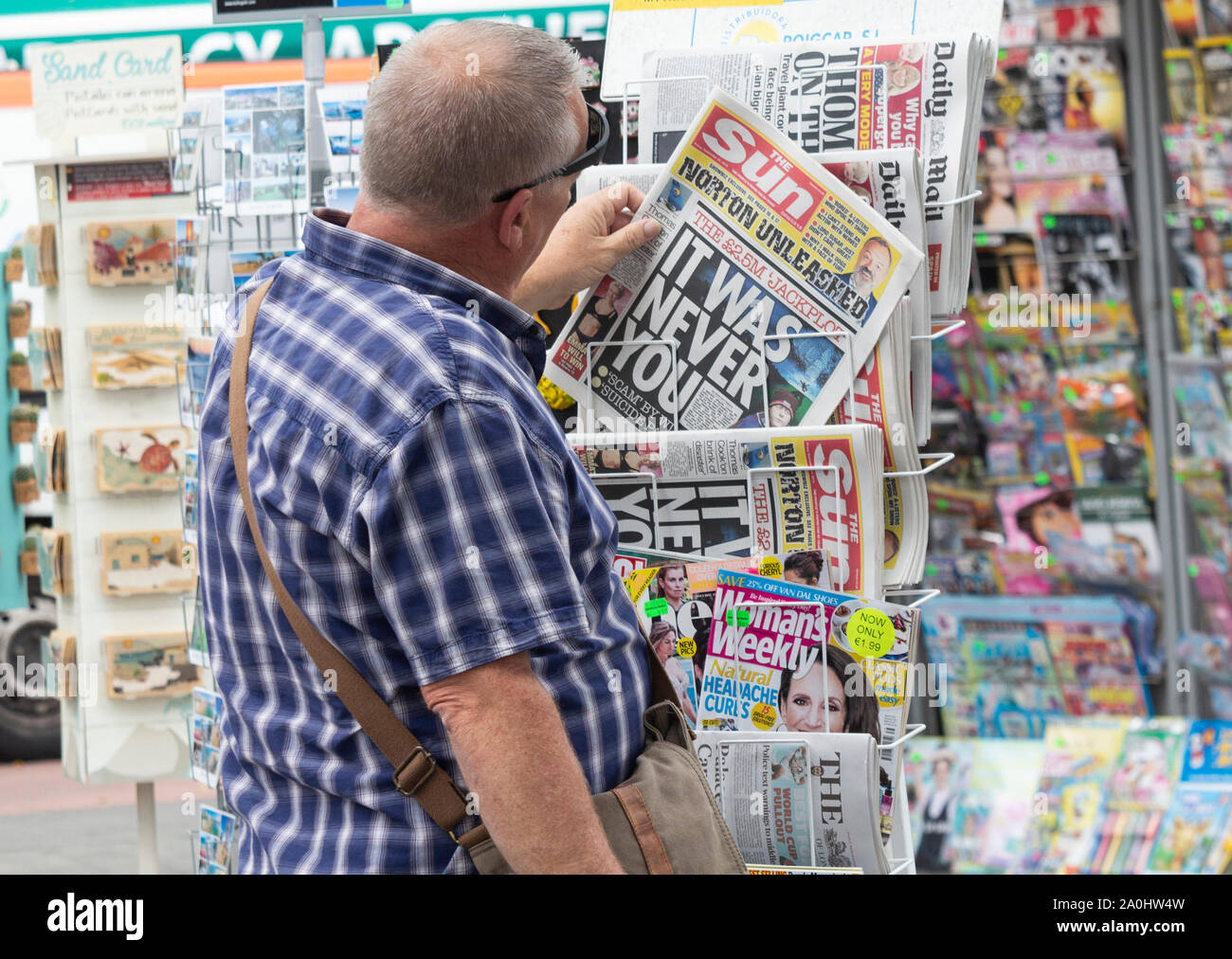 British tourist buying English newspaper in Spain Stock Photo