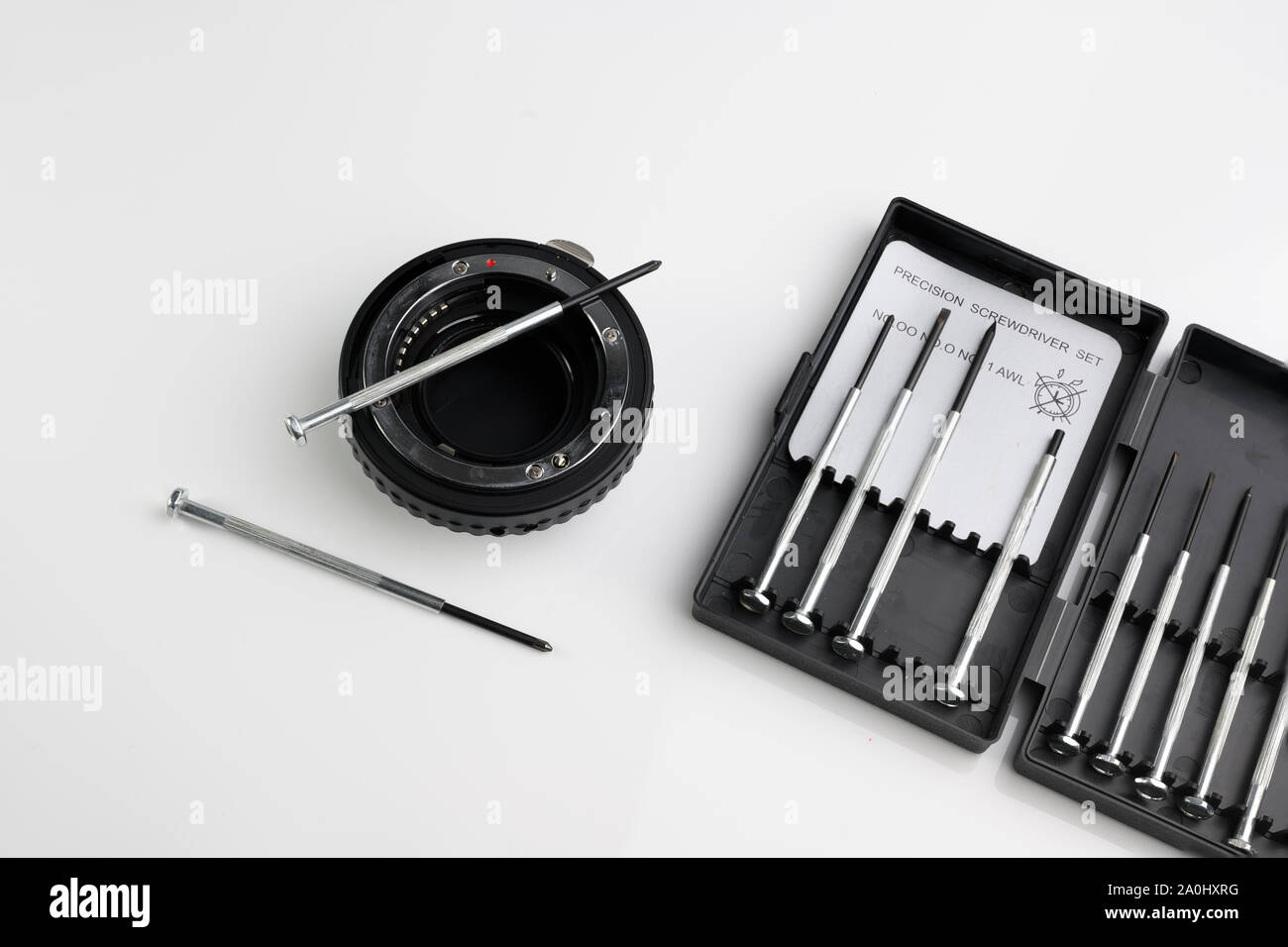 Precision screwdriver repair tool kit set with camera lens on white  background Stock Photo - Alamy