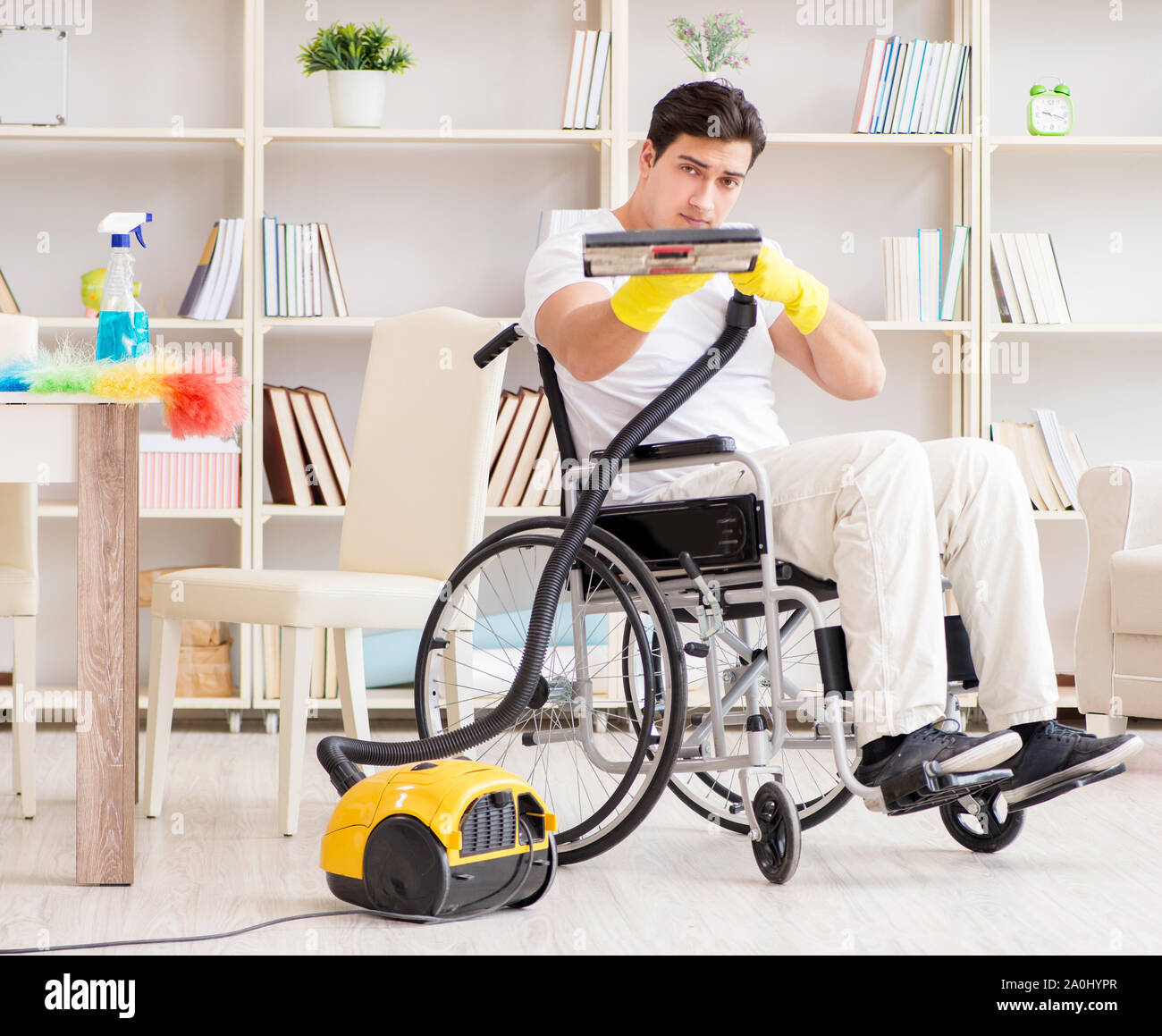 The disabled man with vacuum cleaner at home Stock Photo Alamy