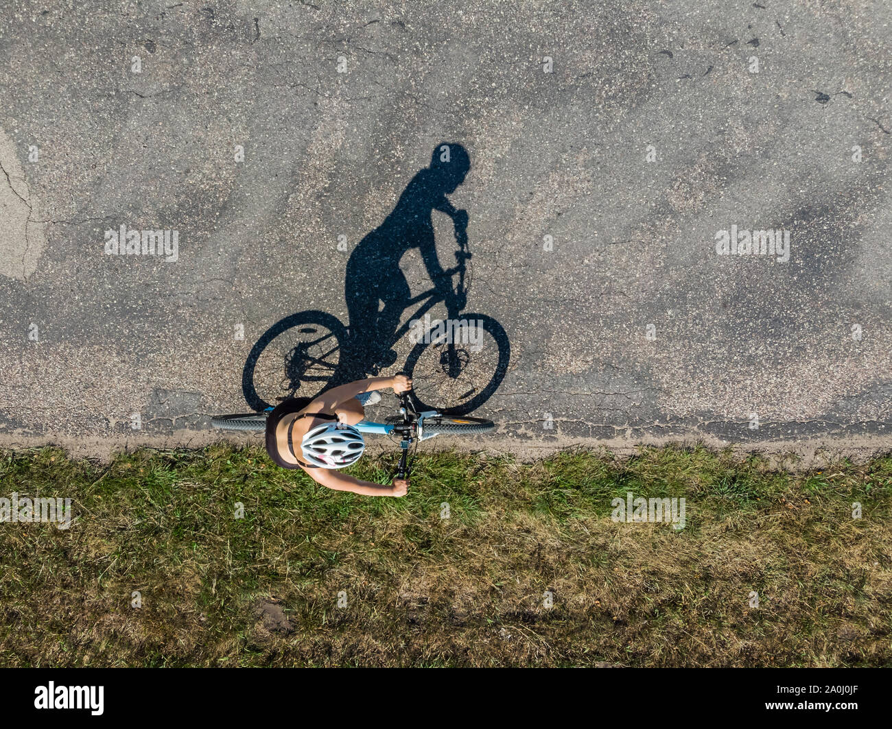 Cyclist on the road, top down image of shadow on the road Stock Photo