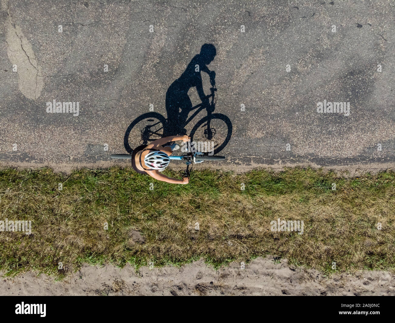 Cyclist on the road, top down image of shadow on the road Stock Photo