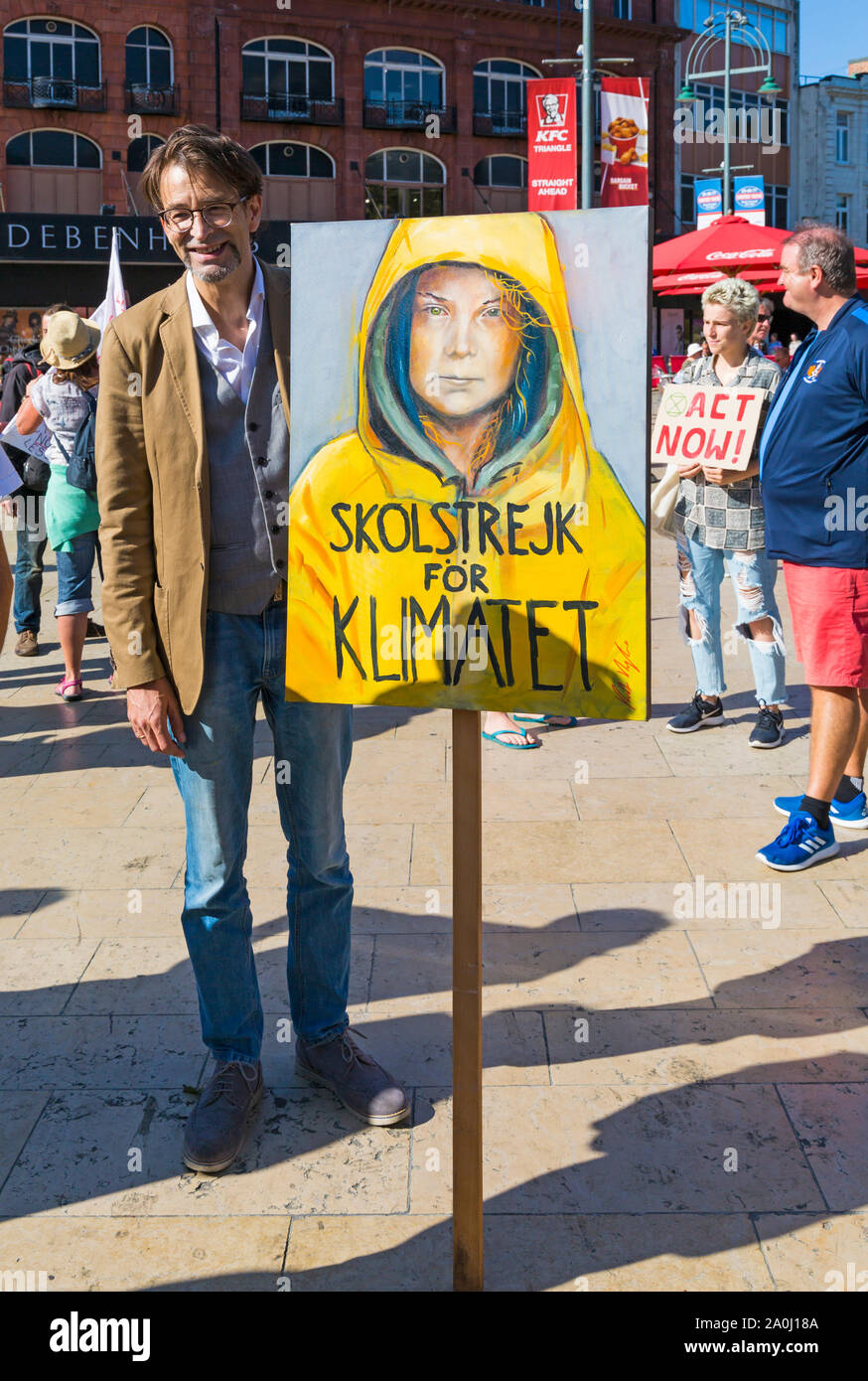 Bournemouth, Dorset UK. 20th September 2019. Protesters, young and old, gather in Bournemouth Square on a hot sunny day to protest against climate change and demand action against climate breakdown from government and businesses to do more. BCP (Bournemouth, Christchurch, Poole) Council have reportedly been threatened with legal action and could be taken to court until they produce proper timely climate change plans. Man holding Greta Thunberg placard in Swedish meaning school march for the climate. Credit: Carolyn Jenkins/Alamy Live News Stock Photo