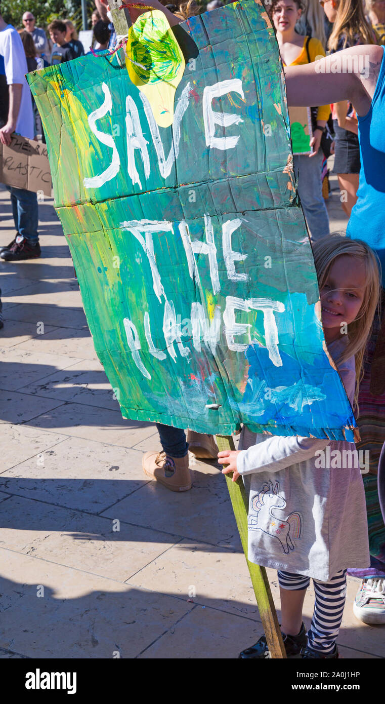 Bournemouth, Dorset UK. 20th September 2019. Protesters, young and old, gather in Bournemouth Square on a hot sunny day to protest against climate change and demand action against climate breakdown from government and businesses to do more. BCP (Bournemouth, Christchurch, Poole) Council have reportedly been threatened with legal action and could be taken to court until they produce proper timely climate change plans. Young girl holding placard - Save the planet. Credit: Carolyn Jenkins/Alamy Live News Stock Photo