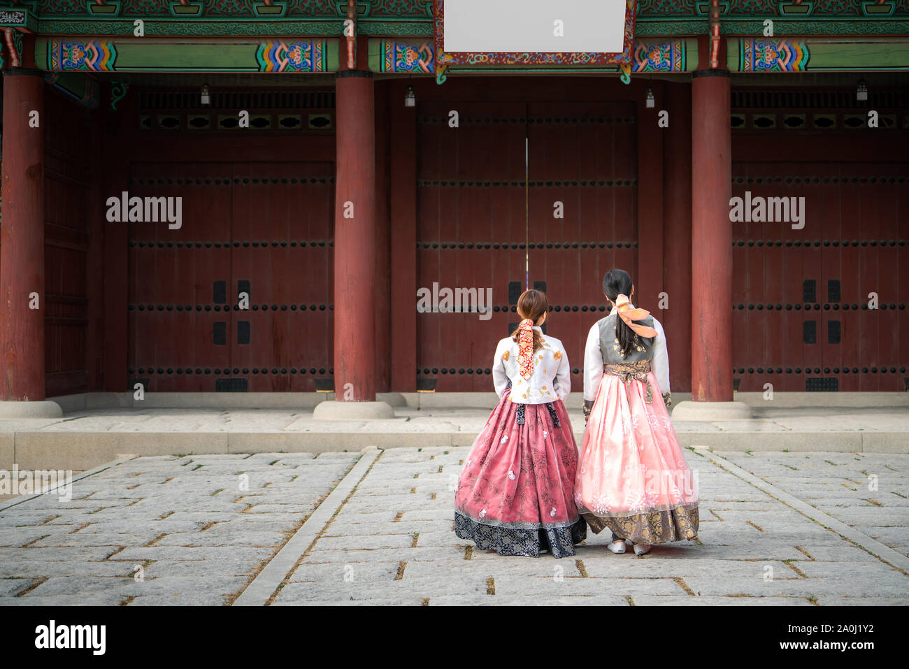 Two Korean women wear hanbok Korea's tradition dress to visit Gyeongbokgung Palace in Seoul,  South Korea. Tourism, summer holiday, or sightseeing Seo Stock Photo