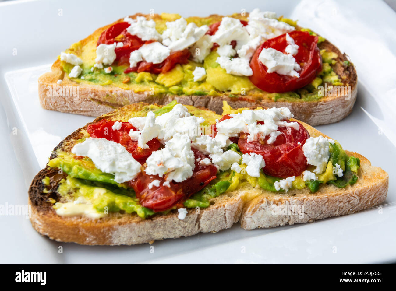 Avocado toast with goat cheese, sundried tomatoes Stock Photo Alamy