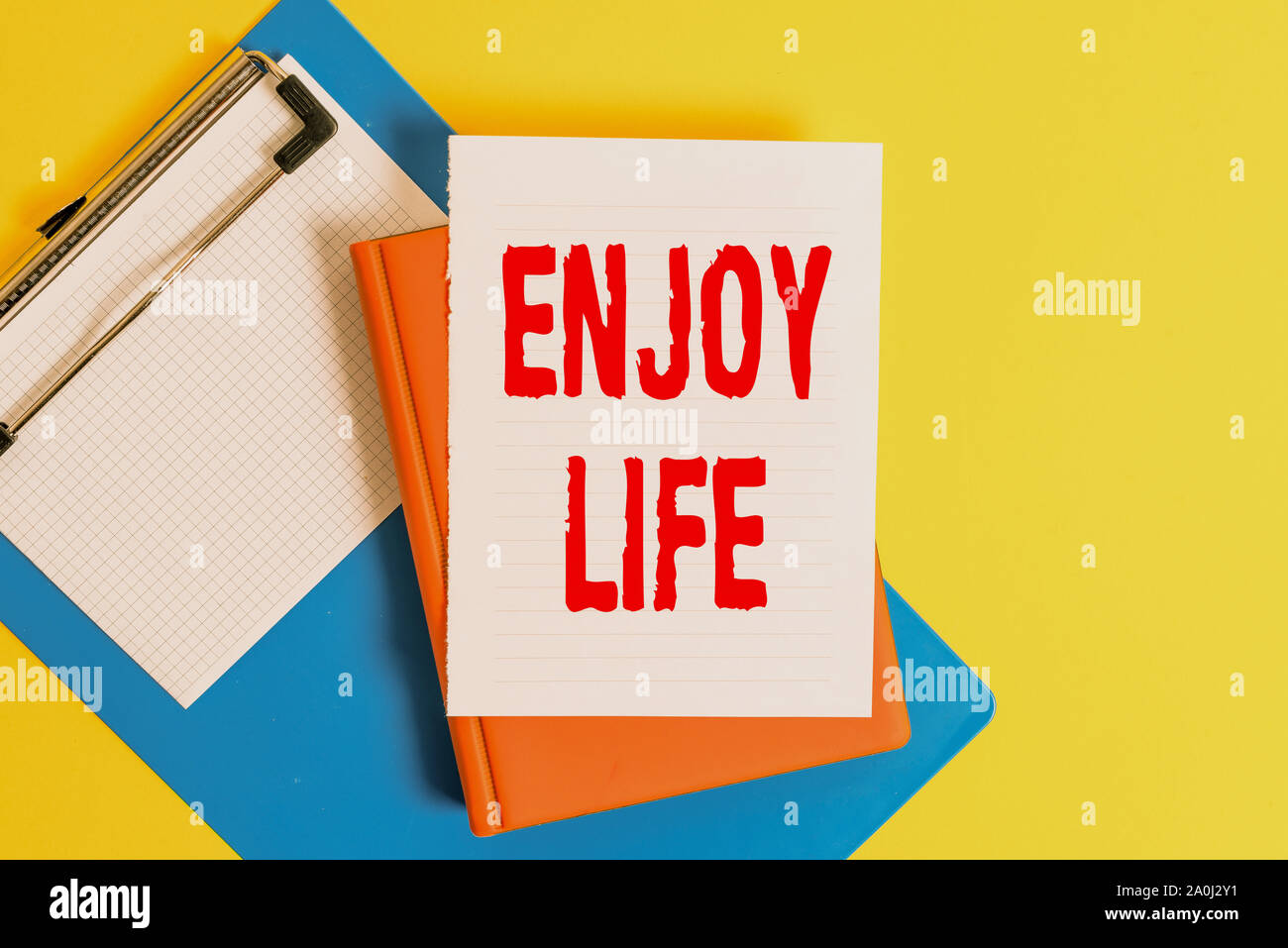 Word writing text Enjoy Life. Business photo showcasing Any thing, place,food or demonstrating, that makes you relax and happy Pile of empty papers wi Stock Photo