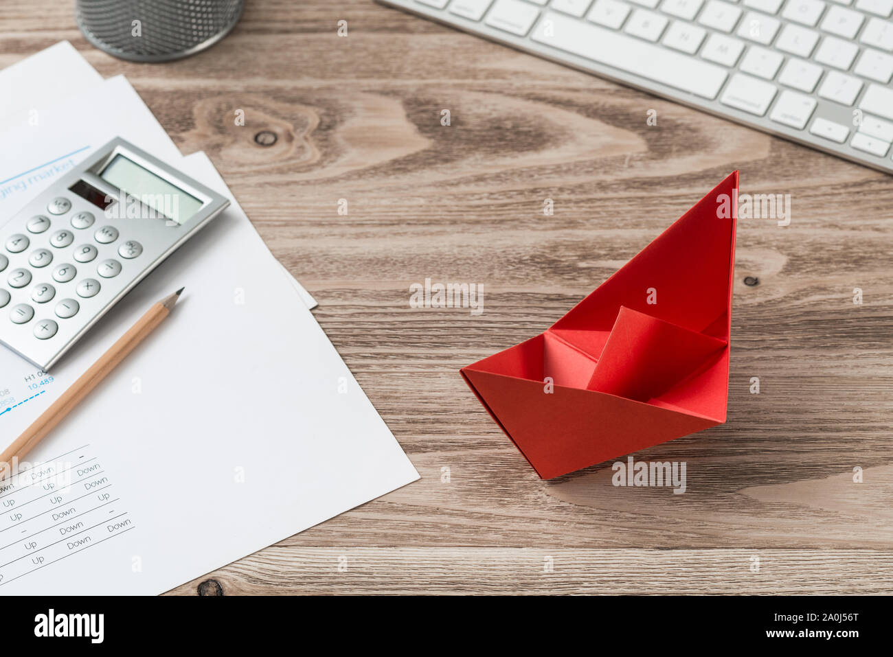 Top View Modern Office Workspace With Red Paper Ship Flat Lay