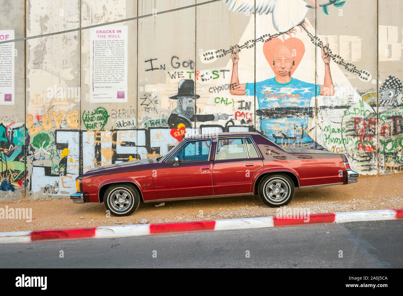Palestine, West Bank, Bethlehem. Oldsmobile Delta 88 vintage car in front of a portion of the