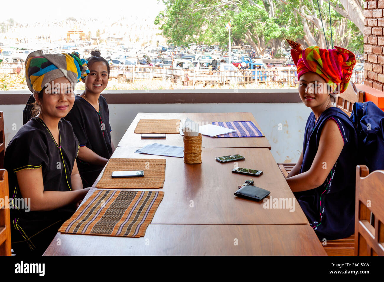 Young Women From The Pa’O Ethnic Group Sitting Inside A Restaurant At The Kakku Pagoda Festival, Taunggyi, Shan State, Myanmar. Stock Photo
