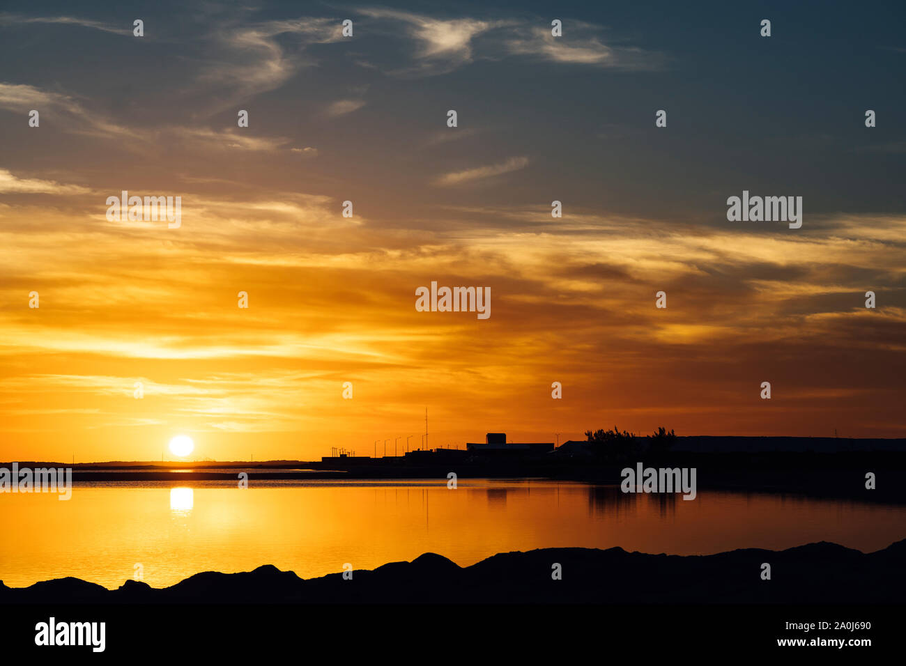 Awesome sunset at the salt flats of Las Coloradas with red waters Stock Photo