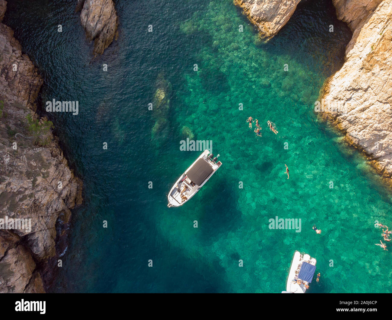 Aerial view of people swimming off boats in a paradise lagoon. Stock Photo