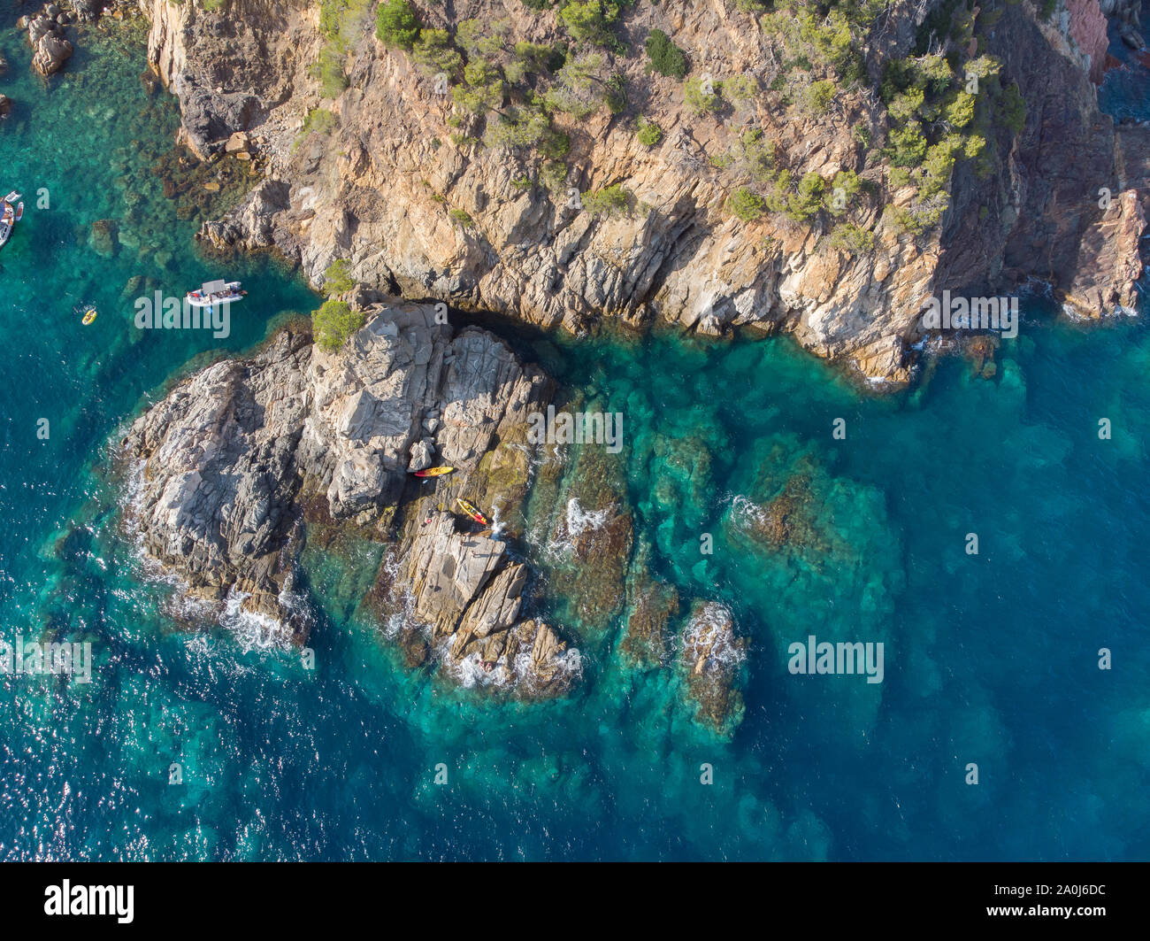 Aerial view of kayaks on a rocky island in the Mediterranean. Stock Photo