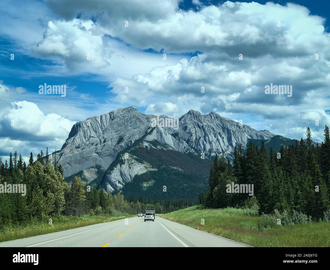 Highway through Banff National park with mountain in the distance. Stock Photo