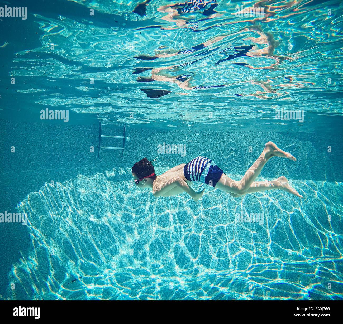 Boy swimming underwater in pool hi-res stock photography and images - Alamy