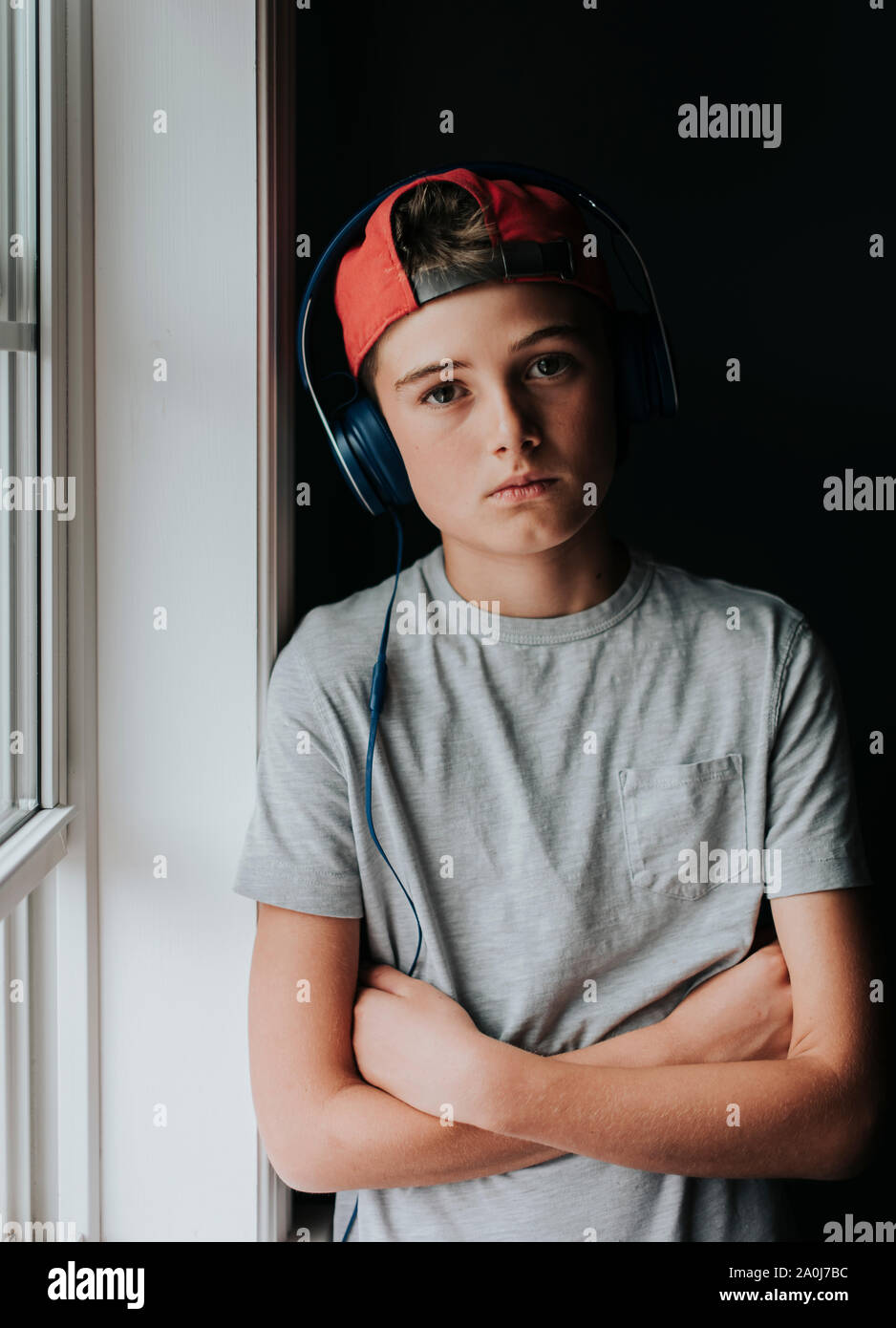 Portrait of tween boy wearing headphones and backwards ball cap Stock Photo  - Alamy