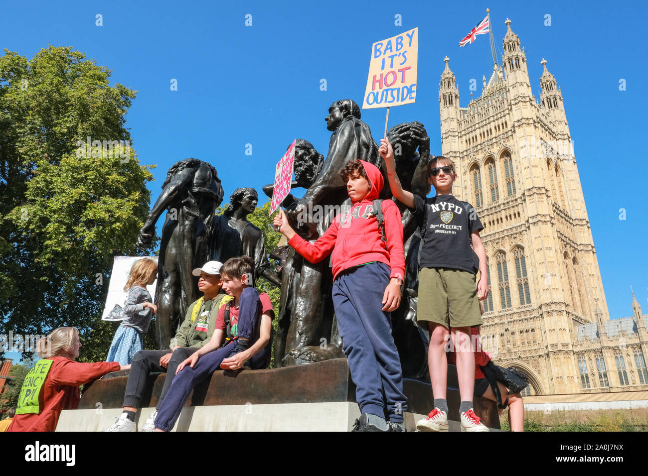 Westminster, London, UK, 20th Sep 2019. Children protest on the 'Burghers of Calais' statue by Rodin. Tens of thousands of children, young people and adults protest for climate action and against the causes of climate change in the British capital. Many similar protests take place in cities around the world in a day of global climate action in an event sparked by the young campaigner Greta Thunberg who attends the global climate strike in New York. Credit: Imageplotter/Alamy Live News Stock Photo