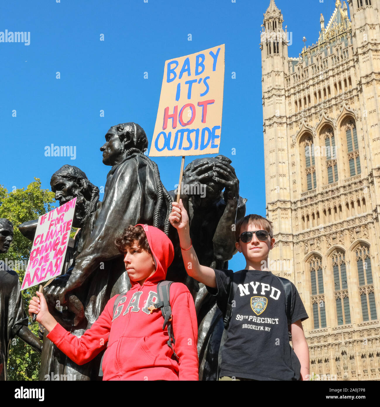 Westminster, London, UK, 20th Sep 2019. Children protest on the 'Burghers of Calais' statue by Rodin. Tens of thousands of children, young people and adults protest for climate action and against the causes of climate change in the British capital. Many similar protests take place in cities around the world in a day of global climate action in an event sparked by the young campaigner Greta Thunberg who attends the global climate strike in New York. Credit: Imageplotter/Alamy Live News Stock Photo