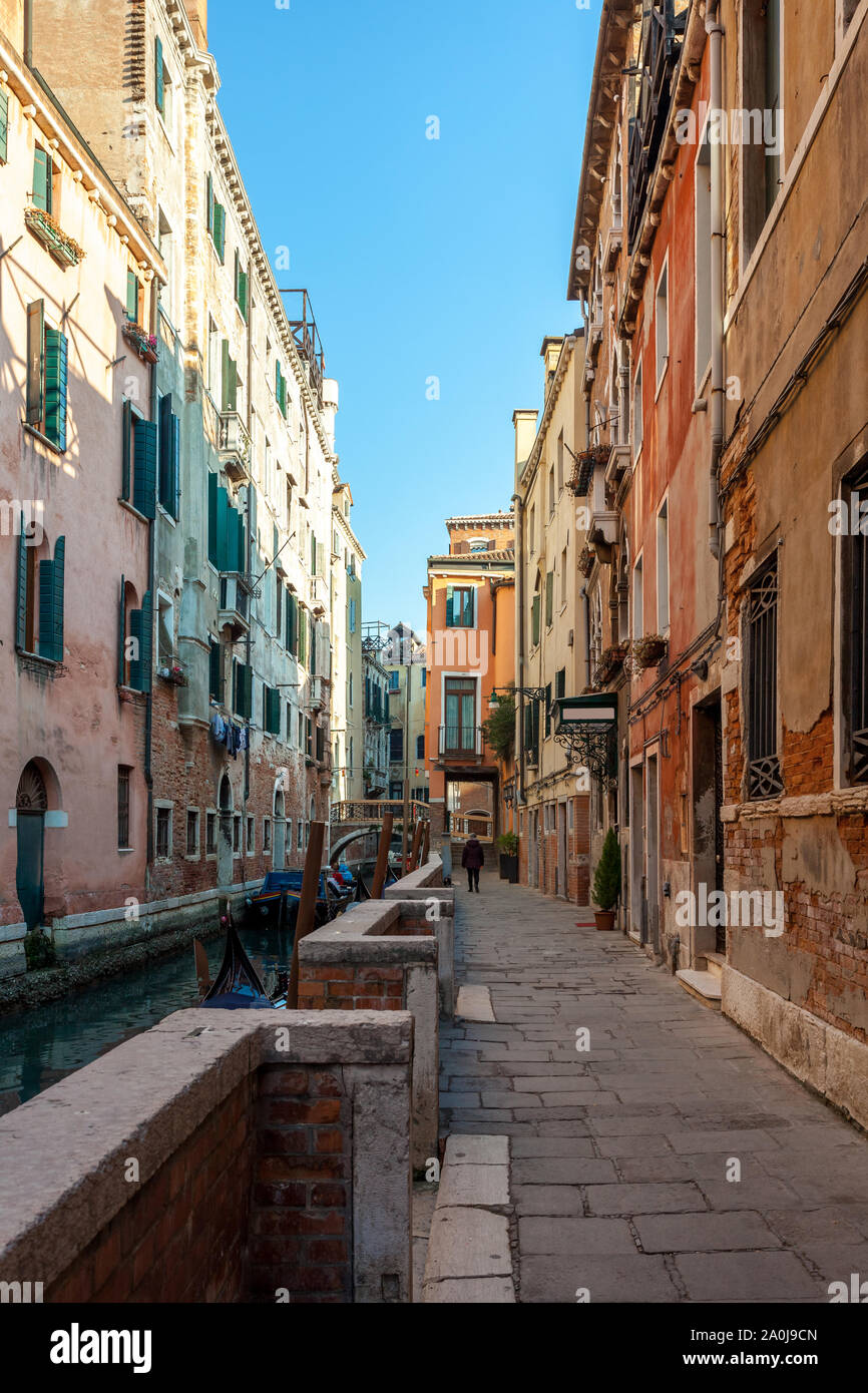 Narrow canal with gondola between houses in venice hi-res stock ...