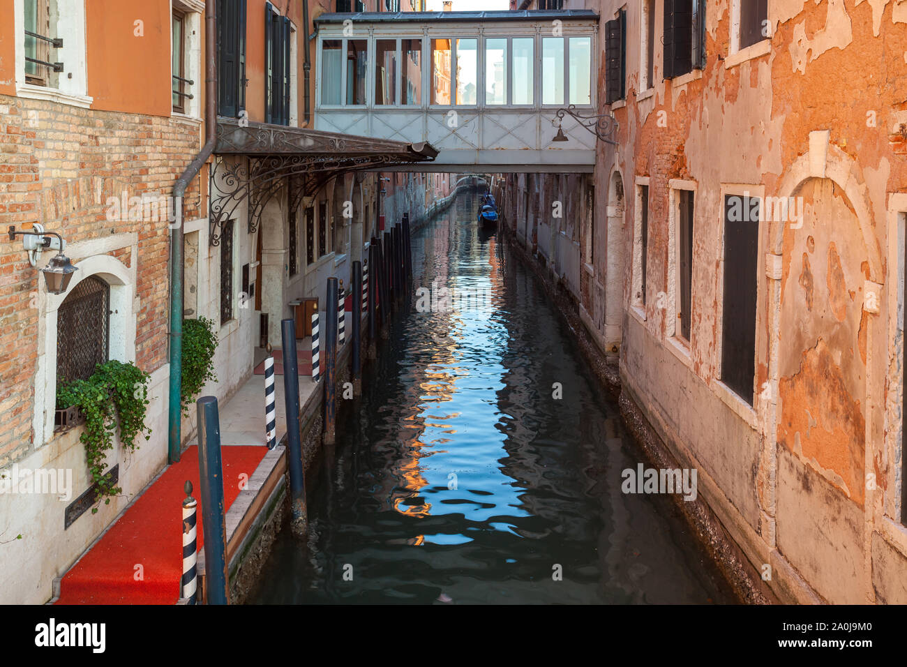 Boats on narrow canal between colorful historic houses in Venice ...