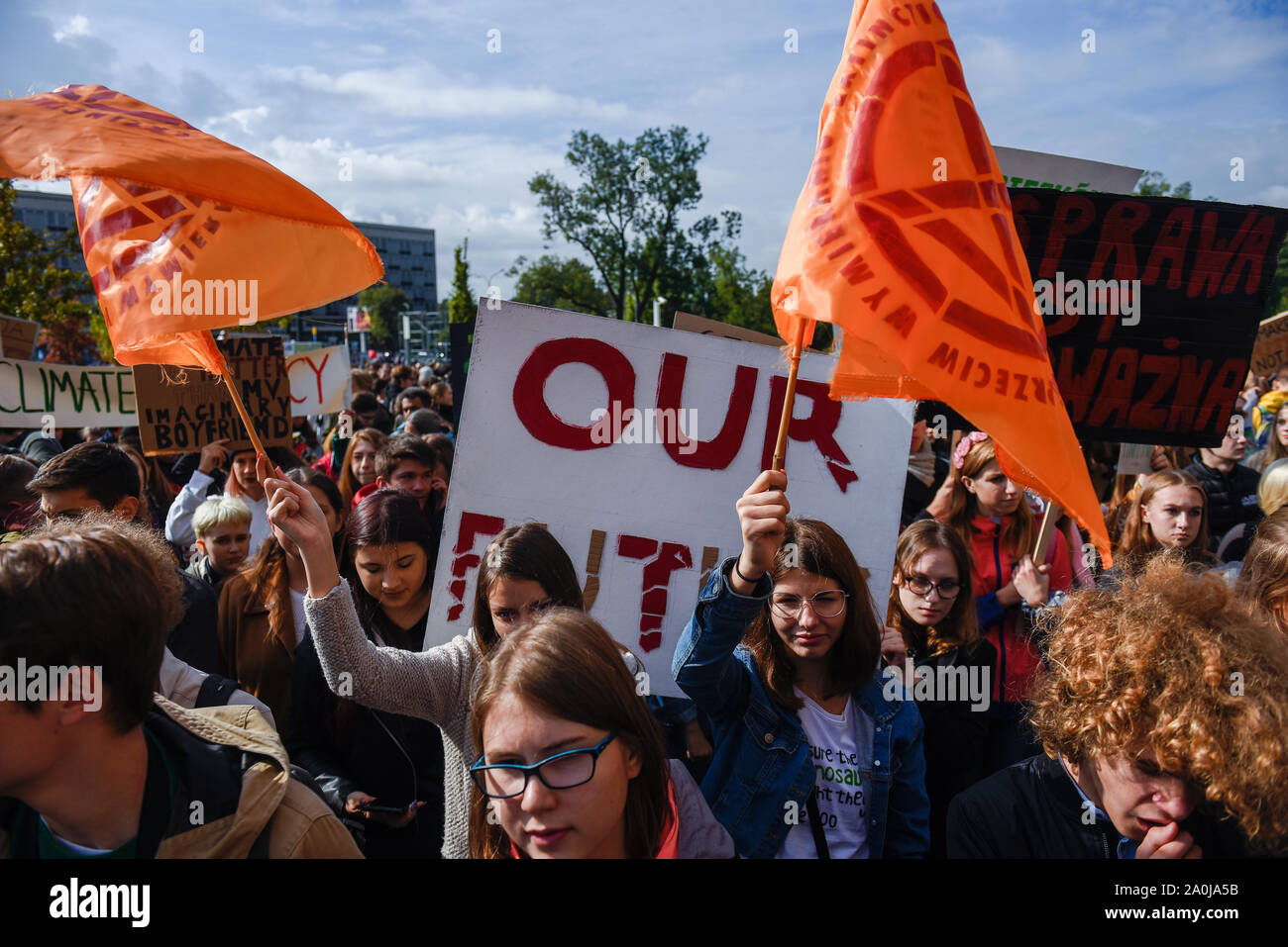 Krakow, Poland. 20th Sep, 2019. Students march while holding flags during the global climate strike day to demand action be taken on climate change.In over 150 countries, people are stepping up to support young climate strikers and demand an end to the age of fossil fuels. Credit: SOPA Images Limited/Alamy Live News Stock Photo